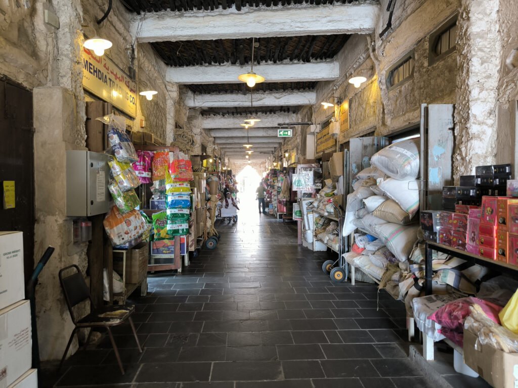 A bazaar street filled with shop stalls on the sides. Souq Waqif, Doha.