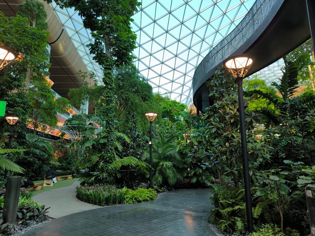The Orchard at Hamad International Airport featuring a small waterfall and a lot of greenery.
