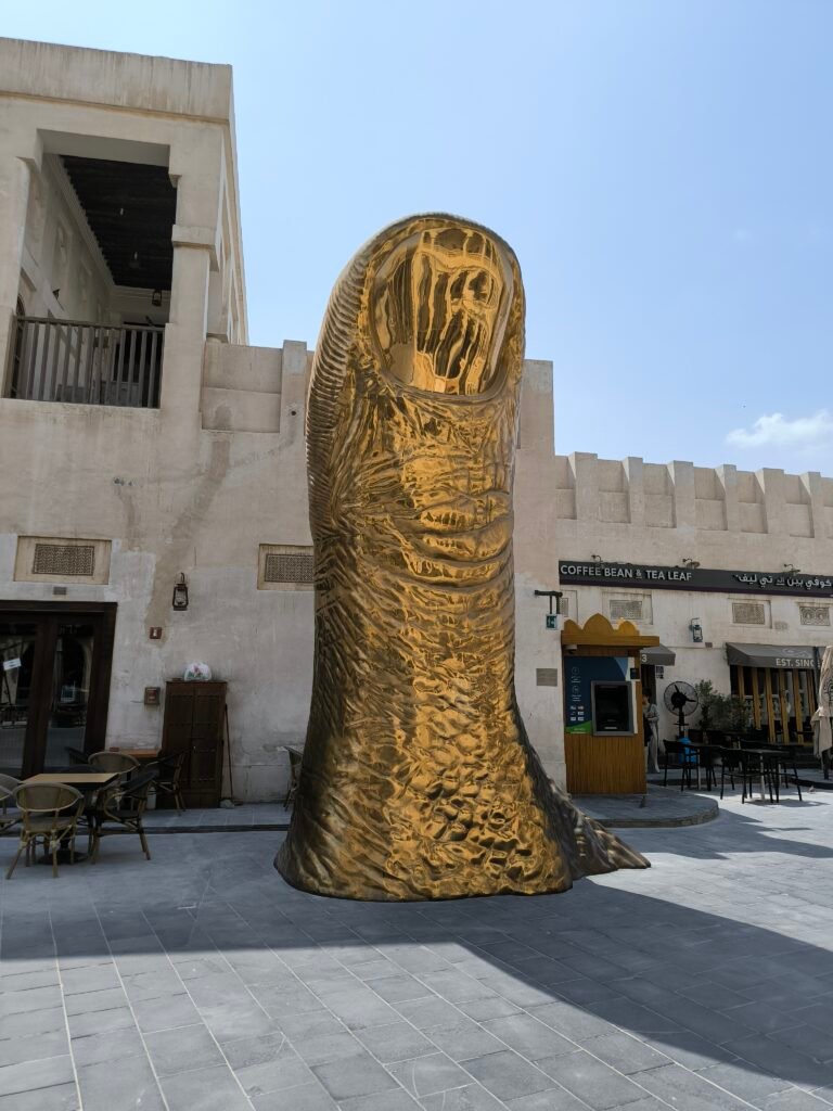 A large statue of a golden thumb located in Souq Waqif, Doha.