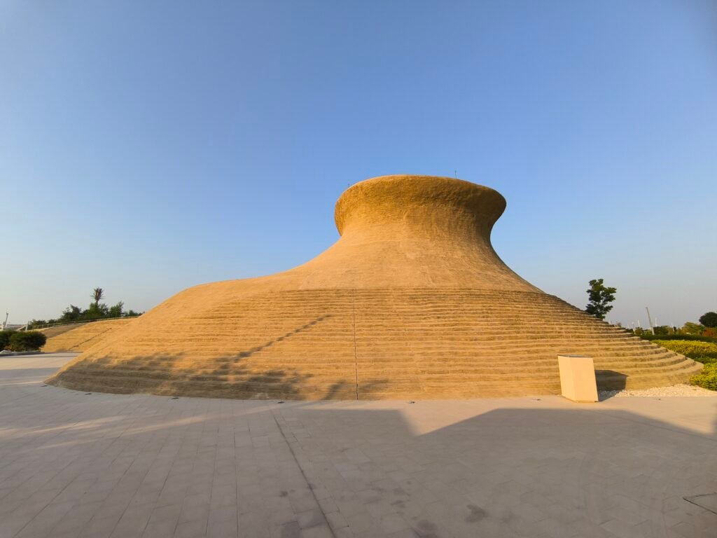 A large and rounded sandstone structure located in Dadu Gardens, Al Bidda Park.